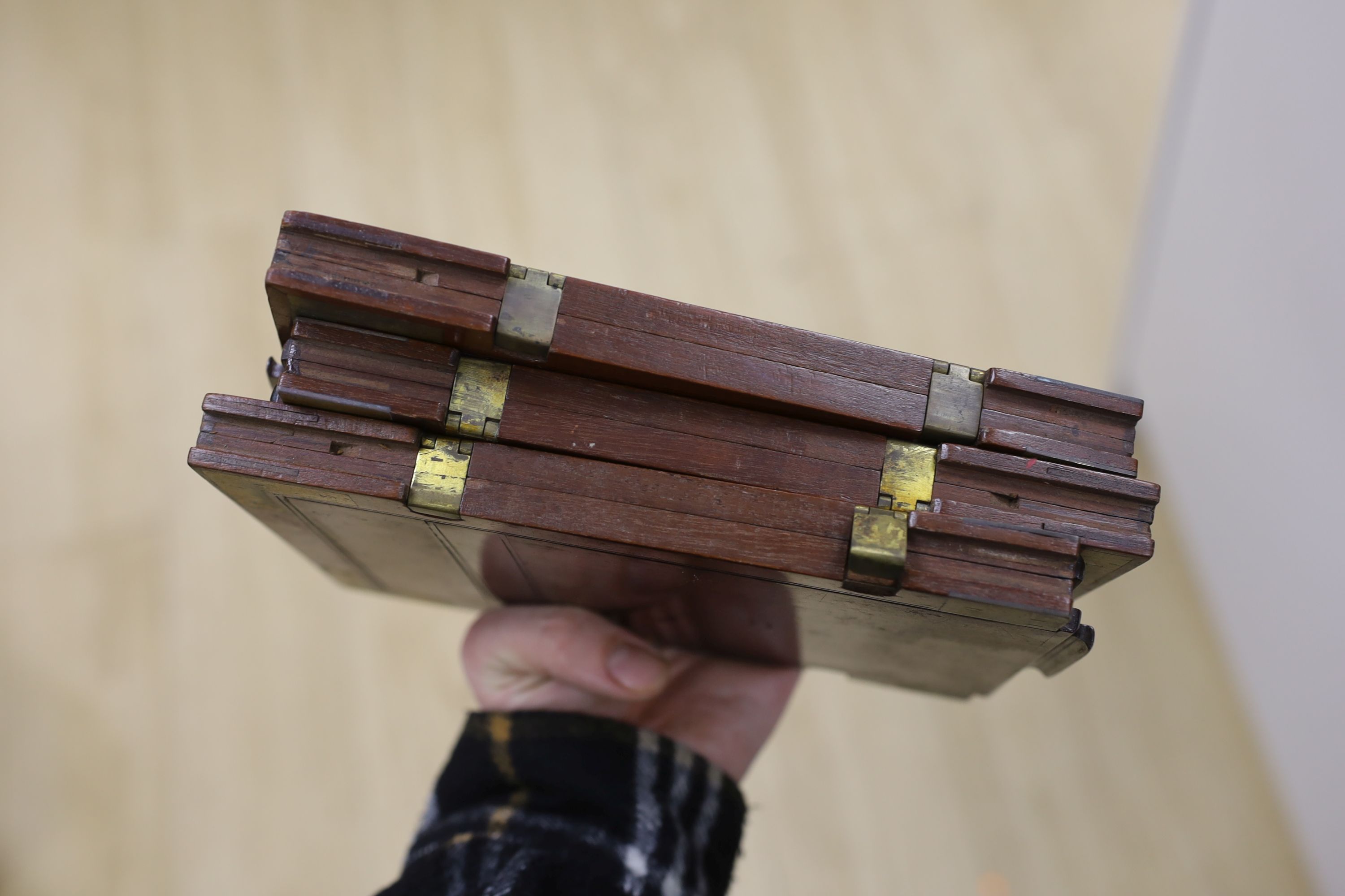 An early 20th century half plate camera by Sands, Hunter & Co. 37 Bedford Street, Strand, London WC, mahogany and brass frame, body 21 x 20cm, in the original leather case, also containing a Taylor, Taylor & Hobson Ltd.